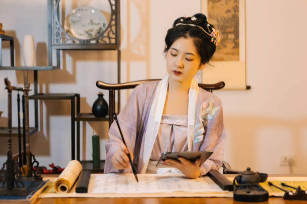 istock Asian Hanfu beauties use tablet computers to draw with brushes 1446947474