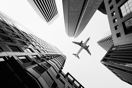 Airplane flying over skyscrapers, San Francisco, California.