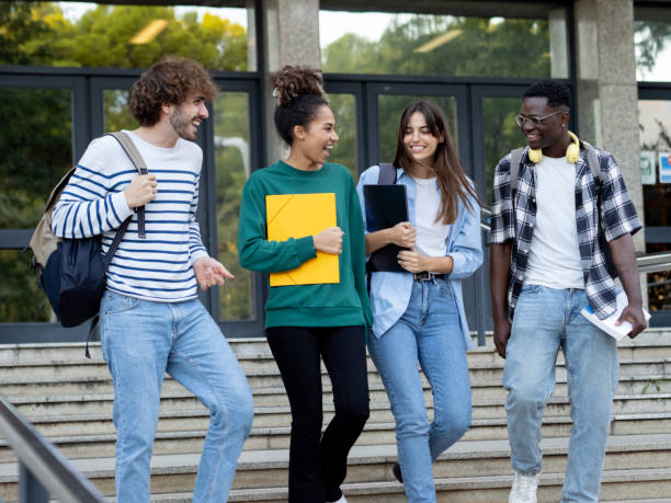 istock Group of diverse college students talking to each other and walking on campus 1446948775