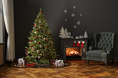 Modern Living Room With Christmas Tree, Miniature Train, Gift Boxes, Fireplace And Armchair