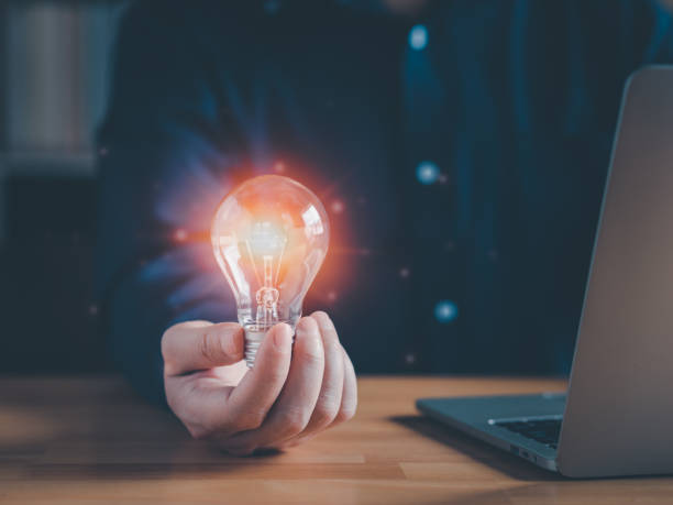 istock Man's hand hold light bulb with use as a substitute of an ideas, innovation, inspiration, technology. 1446949100