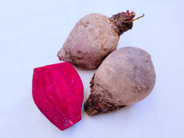 Beetroot red fresh beets redbeet gardenbeet tablebeet dinnerbeet goldenbeet commonbeet a taproot portion of a beet plant chukandar vegetable food closeup view image picture stock photo remolacha roja fresca remolacha roja remolacha roja de jardín remolacha de mesa de remolacha remolacha dorada remolacha común una porción de raíz principal de una planta de remolacha chukandar entera y cortada por la mitad cortada a la mitad comida veg