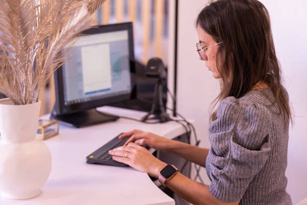 istock Focused female entrepreneur working on computer at table in office 1446952565