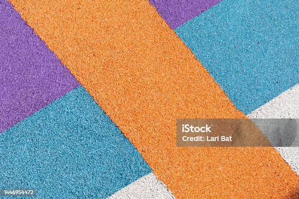 Special Rubber Coating For Playground Or Sports Activity Junction Of Multicolored Pieces Of Floor Covering Made Of Recycled Materials Padded Floor Covering With Rubber Granules Stock Photo - Download Image Now