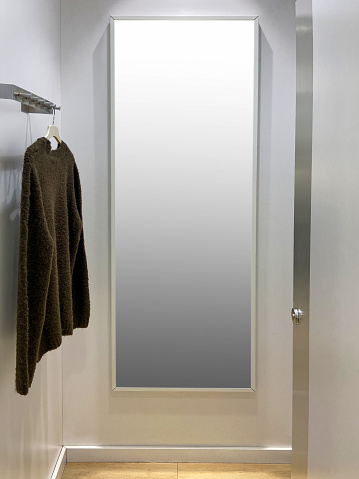 Dressing room with full length mirror and mirror frame with clipping path. Clothing store dressing room