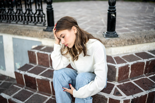 Young woman feeling bad outdoors