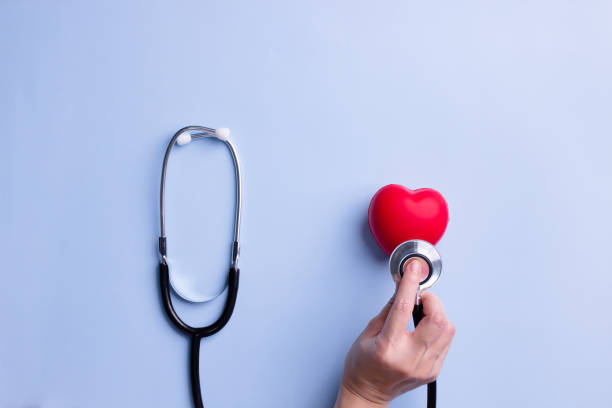 woman hand use stethoscope to listen to red heart rate to diagnosis disease. healthcare concept. - nurse illness doctor heart disease imagens e fotografias de stock