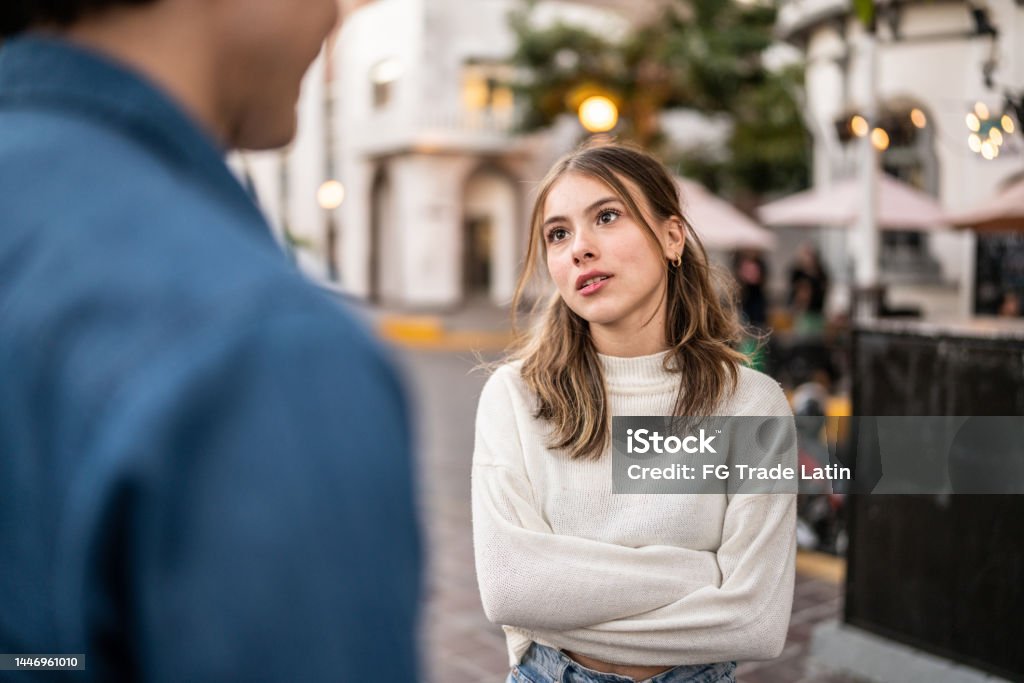 Young couple having an argument outdoors Couple - Relationship Stock Photo
