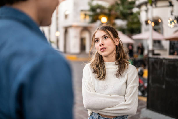 Young couple having an argument outdoors stock photo