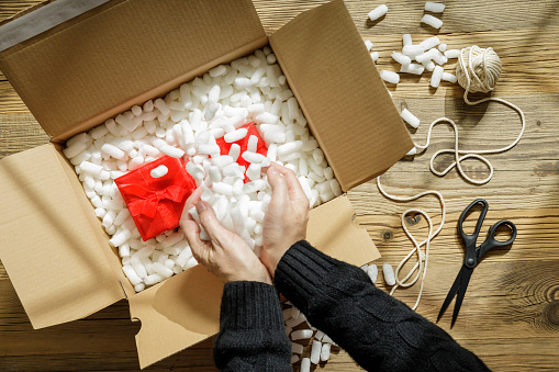 packing a gift in a cardboard box