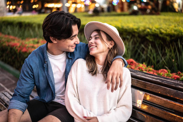 Young couple embracing and talking outdoors