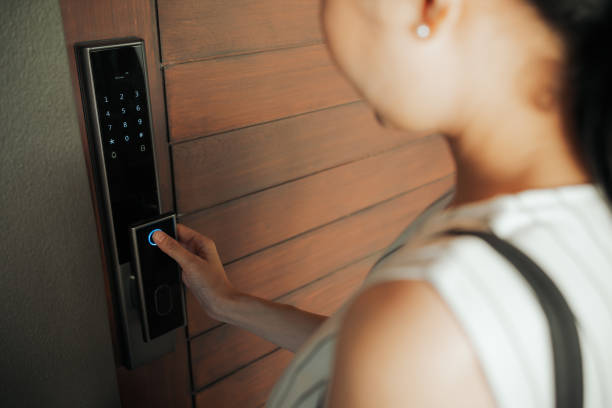 istock Woman hand Pressing down on electronic access control at door house 1446961617
