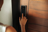 Close-up Woman hand Pressing down on electronic access control at door house