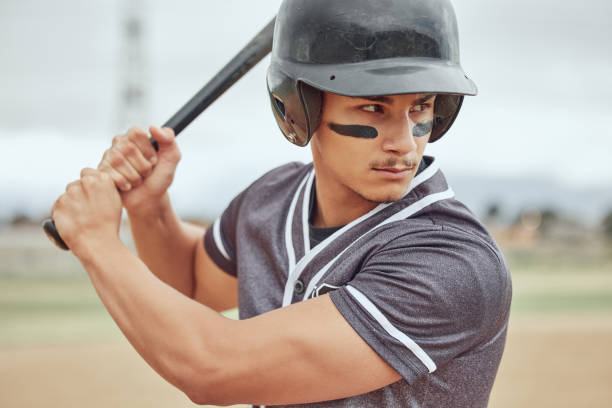 istock Baseball player, bat and athlete on a field ready for the game or training with motivation, focus and champion mindset. Softball, fitness and sports man playing a professional match on outdoor pitch 1446963065