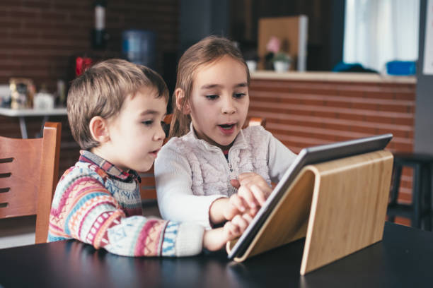 istock Children playing video game on digital tablet 1446963385