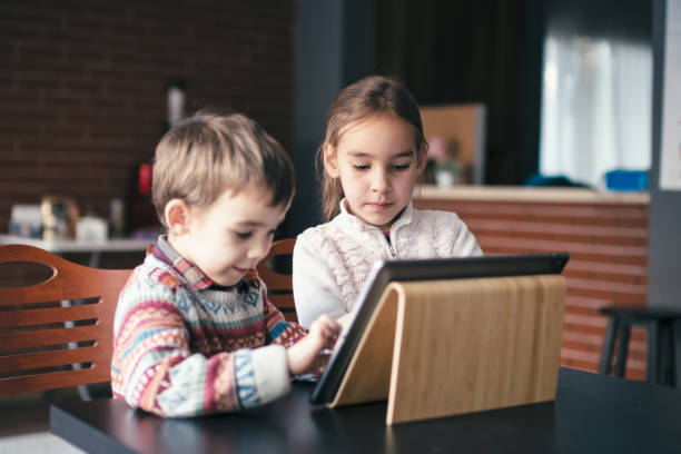 istock Children playing video game on digital tablet 1446963655