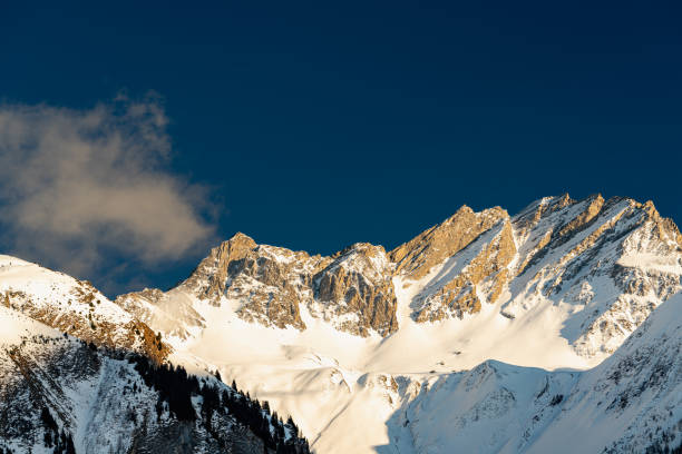istock Alpine mountain peaks glow in the winter evening sun 1446964689