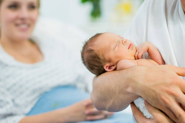 istock Dad Holding His New Baby 1446966179