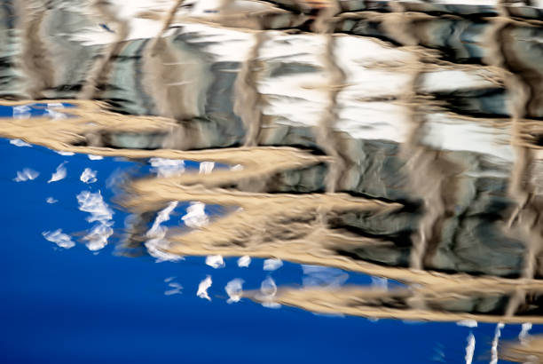 istock Abstract background of rippled water surface with distorted buildings reflections. Water background with copy space for graphic design 1446968948
