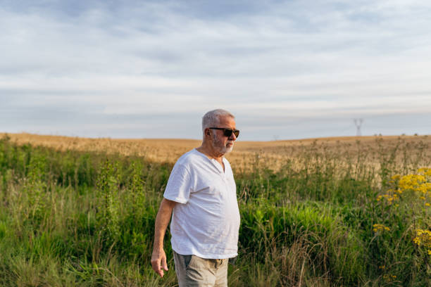 istock Senior man walking on the farm 1446970074