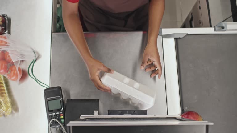 Cashier Working at Cash Desk in Supermarket Top View