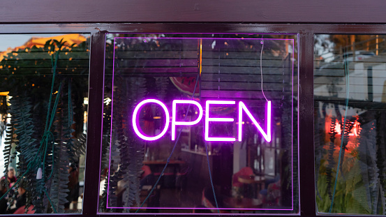 neon sign with the word open