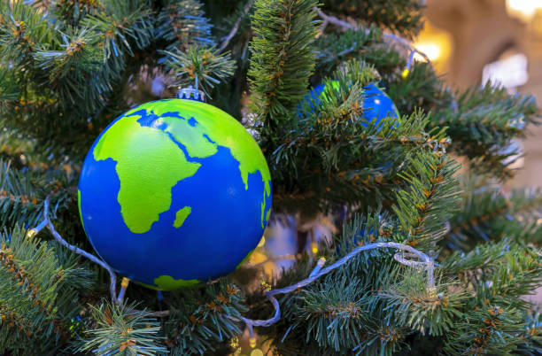 istock Globe-shaped Christmas ball with countries and continents on the Christmas tree. 1446973651