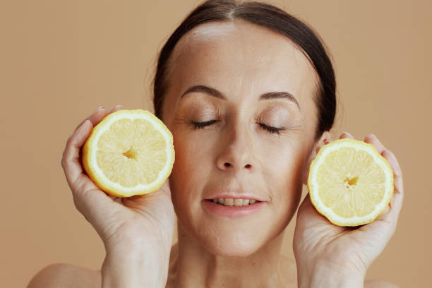 istock modern female with lemon isolated on beige background 1446974332
