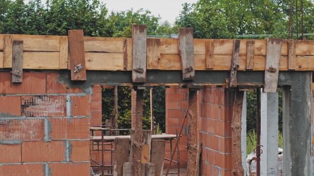 istock Red Brick Detached House Construction Site with Ceiling Formwork Supported by Steel Telescopic Bearer 1446975779