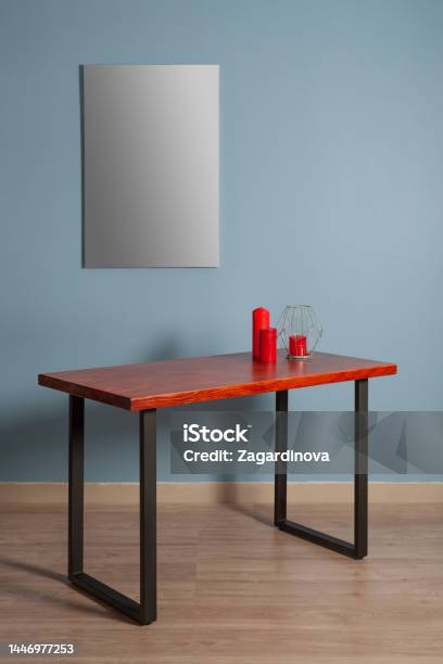White Canvas For Painting On A Wooden Table Against A Blue Wall In The Interior Mockap Stock Photo - Download Image Now