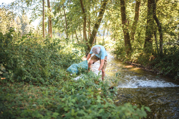 istock Mature Man Cleaning up the Environment in Nature 1446977679