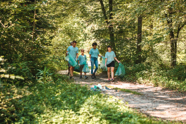 istock Environmental Clean Up Crew Carrying Bags 1446977834