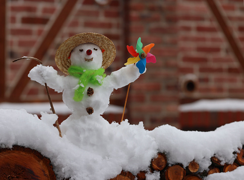 little snowman with toy pinwheel