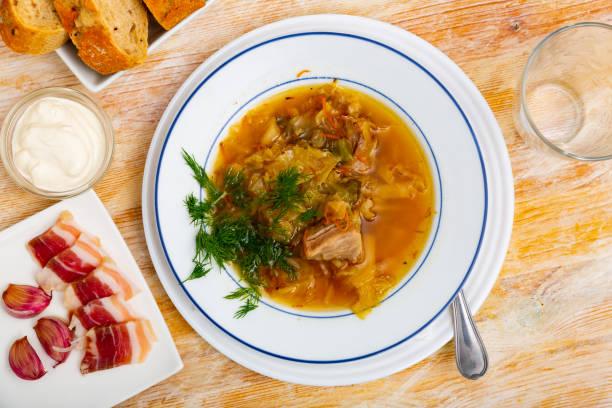 istock Shchi, cabbage soup cooked on mushroom broth with pork and sour cream 1446979261