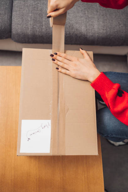 istock Woman preparing a package for shipment 1446980476