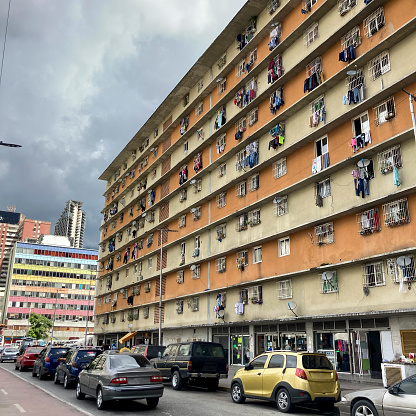 In the city of Caracas towards the center of the capital of Venezuela, a lower middle class building can be seen in the windows of the apartments, clothes drying in the open air, some do it to save electricity and lead a more economically sustainable life.