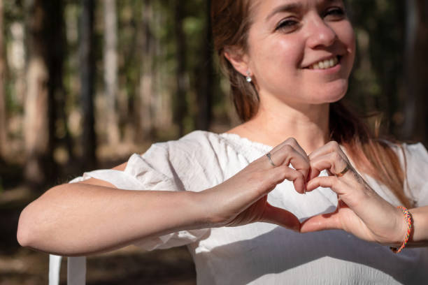 istock Young woman making a heart with her hands. 1446985169