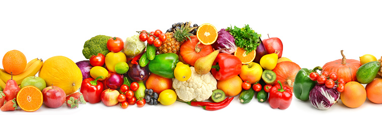 Top view of various multicolored fruits and vegetables disposed side by side at the center of the image on a stripe shape leaving a useful copy space at the top and at the bottom on white background