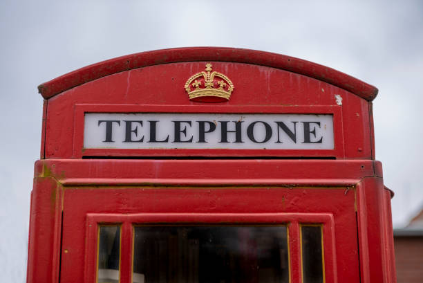 An old British telephone booth in red. Old phones. communication.