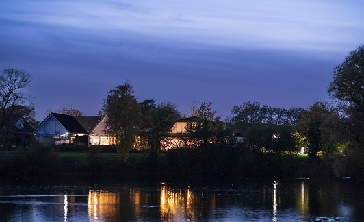 lights of houses by the lake at sunset. Gronau, Germany