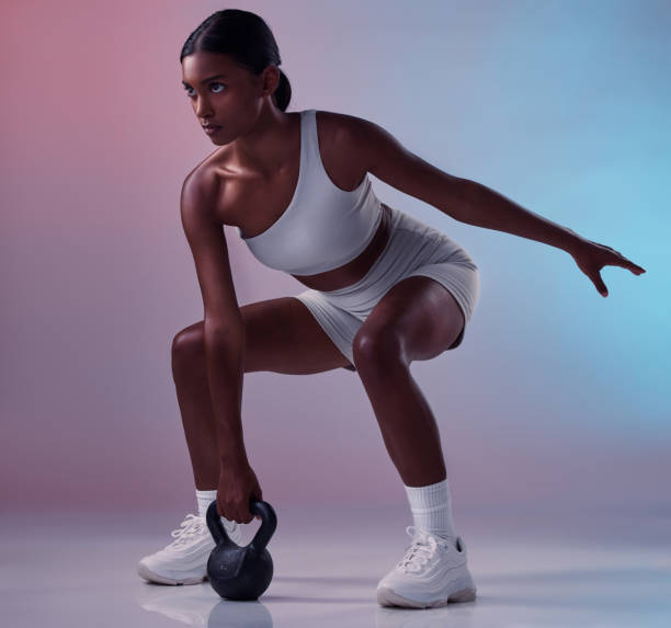 istock Woman, kettle bell weights or workout on studio background for strong body muscles, exercise or training. Personal trainer, sports person or fitness model weightlifting heavy metal in health wellness 1446989366