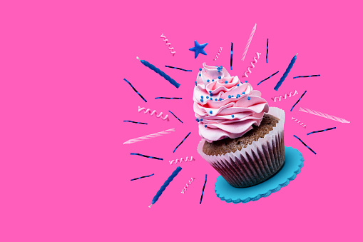 Sweet cupcake with birthday decoration on pink background