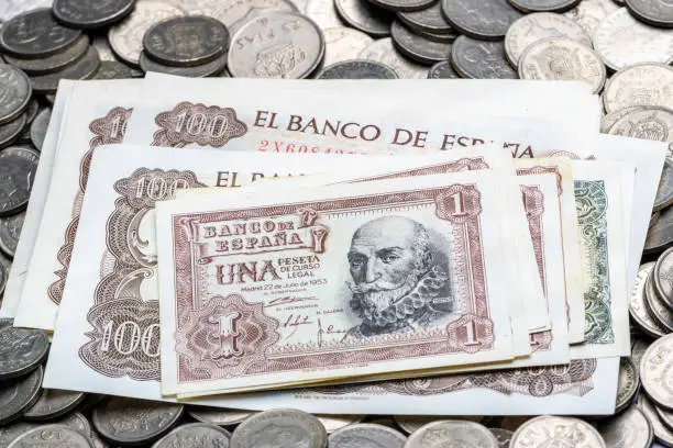 Photo of Peseta bills on Spanish coins