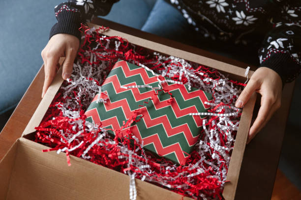 istock Young woman unpack the package with present 1446990769
