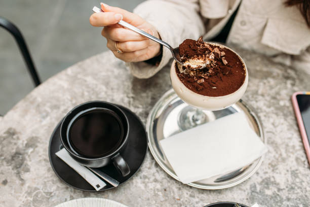 eating homemade tramisu with americano - espresso women cup drink imagens e fotografias de stock