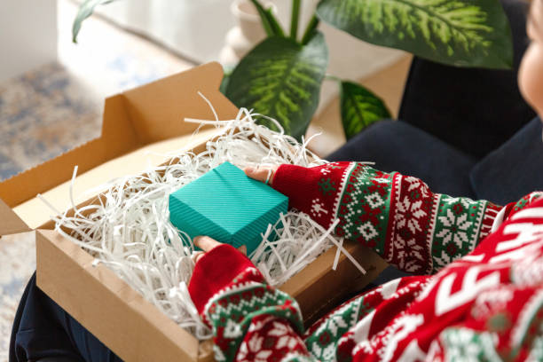 istock Young woman unpack the package with present 1446994551