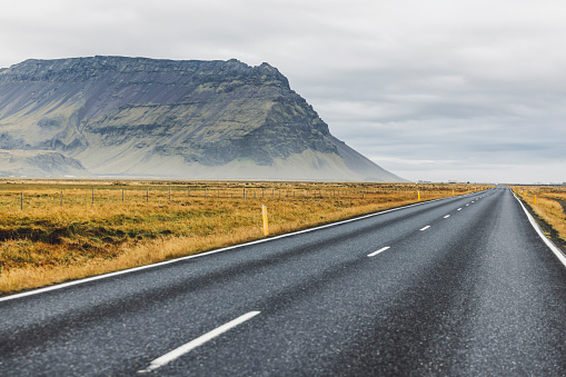 Road and mountain view during road trip in iceland. Foggy landscape in autumn time. High quality photo
