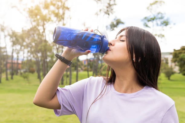 istock young woman drinking water after 1447000668