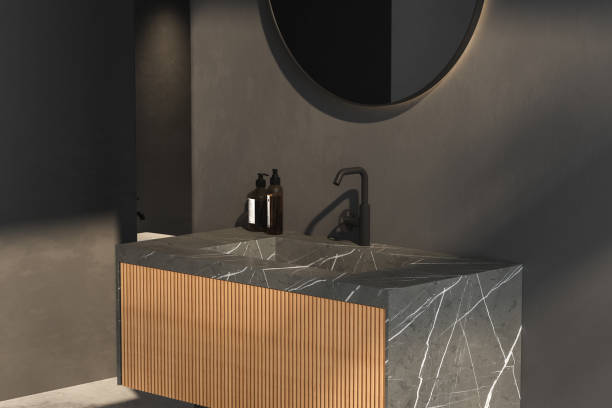 Close up of marble basin with oval mirror standing in on dark wall, wooden cabinet, black faucet in minimalist bathroom. Side view. 3d rendering stock photo