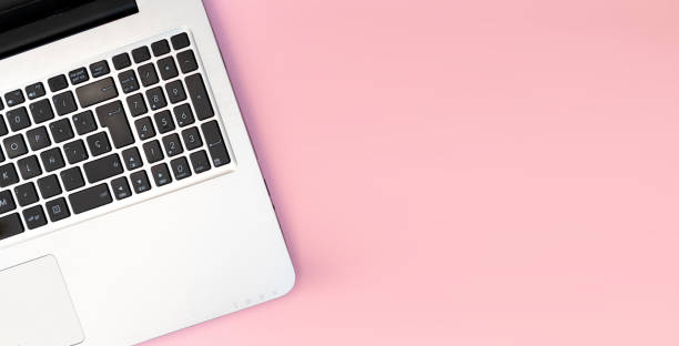 istock Pink work station, clear surface for copy space, indoor office with laptop 1447004247